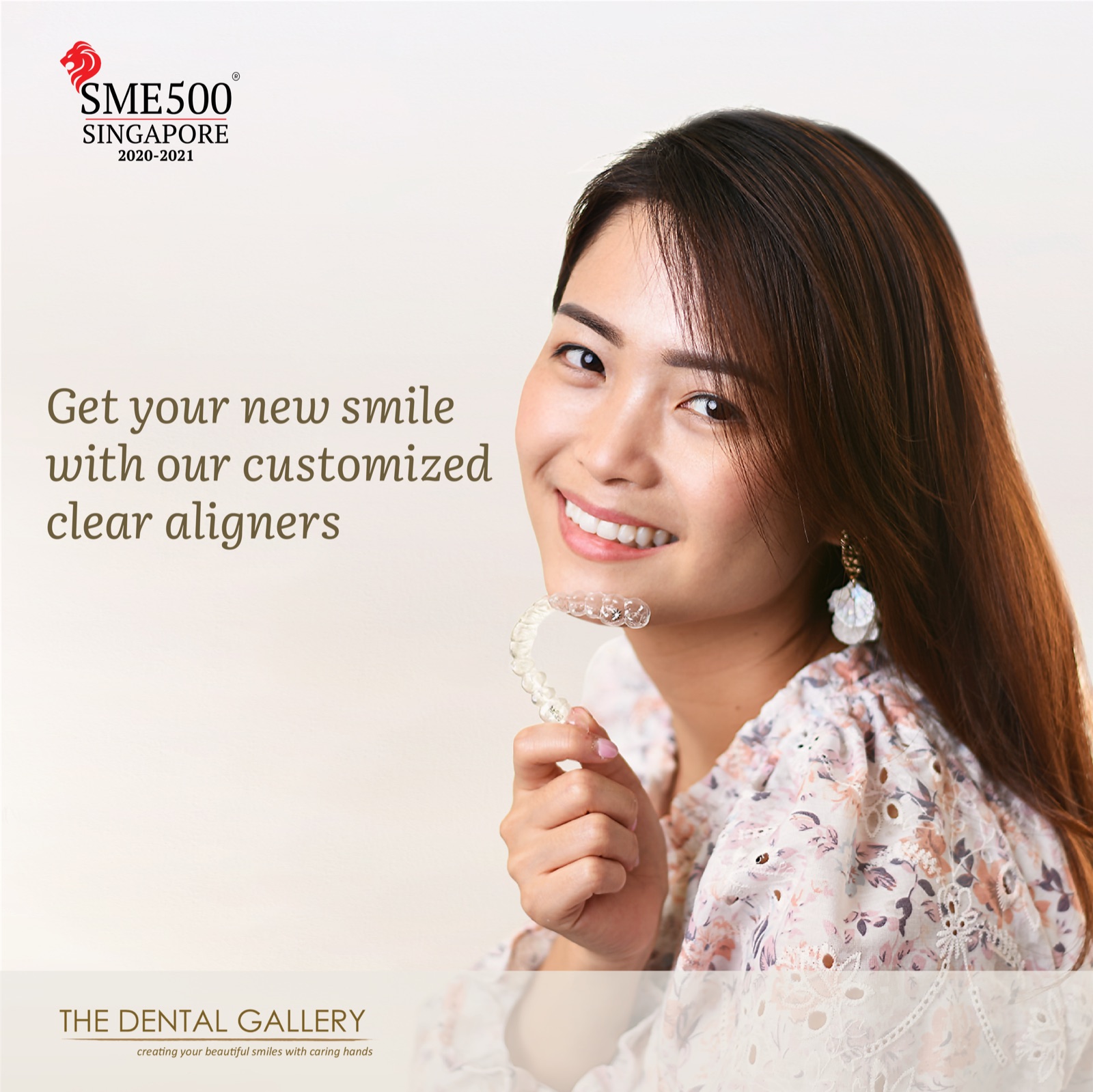 Woman smiling while holding a clear aligner, with the words "Get your new smile with our customized clear aligners"